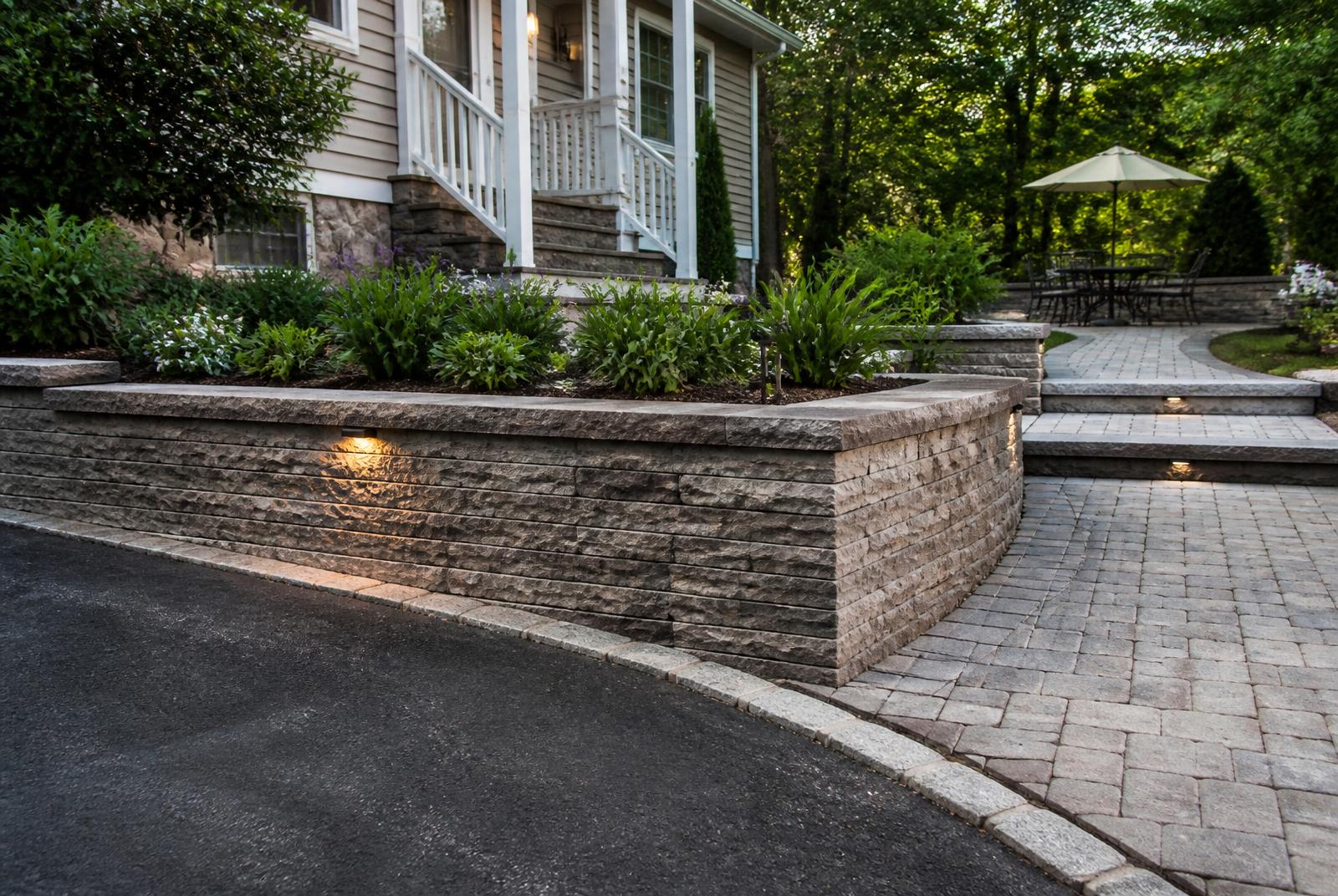 Retaining wall, paver walkway and asphalt driveway at a residential property
