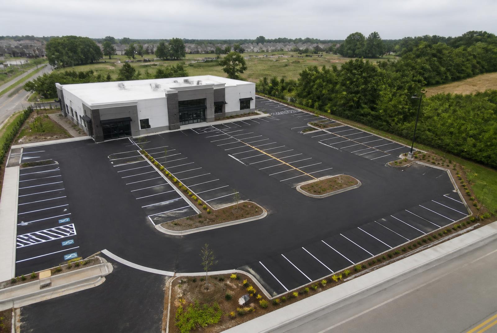 Freshly paved commercial parking lot with new striping